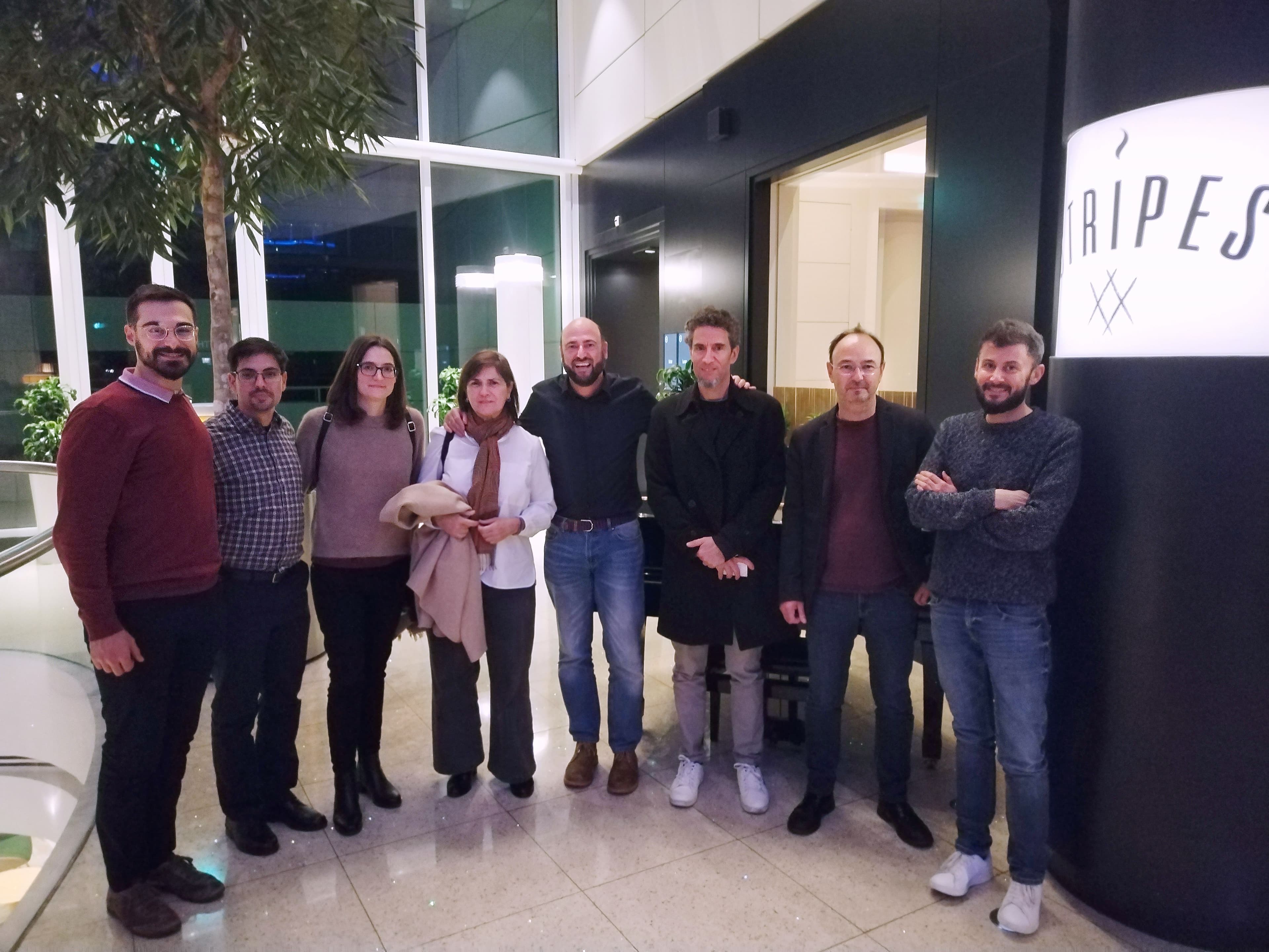A group of scientists indoors smiling towards the camera